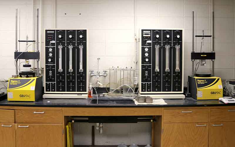 lab equipments with gauges, knobs, clear tubes for soil and aggregated materials